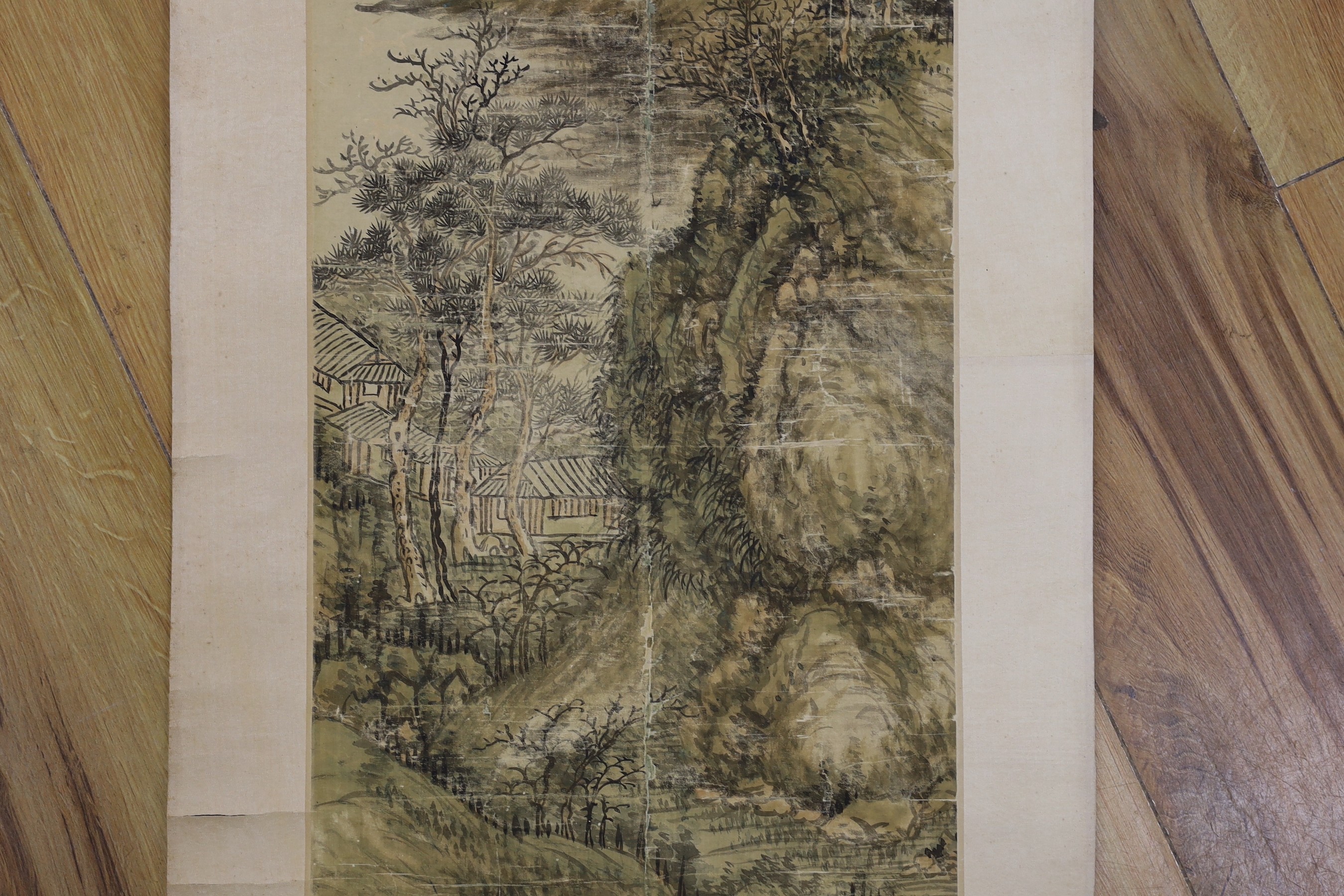 A Chinese landscape scroll painting on silk, Qing dynasty inscribed and signed, artist’s seal and collector’s seal lower left, image 139cm x 27.5cm, remounted